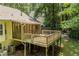 Elevated deck and screened porch provide an outdoor space overlooking a wooded backyard at 217 Bridgewater Trl, Canton, GA 30115