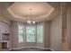 Bright dining space with tray ceiling, modern chandelier and large windows at 217 Bridgewater Trl, Canton, GA 30115