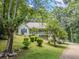 Charming home with a welcoming porch and well-maintained landscaping, surrounded by mature trees at 217 Bridgewater Trl, Canton, GA 30115