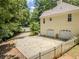 Home's exterior boasts an attached garage and long driveway, surrounded by trees and a white picket fence at 217 Bridgewater Trl, Canton, GA 30115