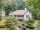 Inviting home with charming stone accents, a spacious porch, and lush landscaping, perfect for outdoor living at 217 Bridgewater Trl, Canton, GA 30115