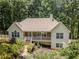 Beautiful home featuring stone accents, a covered porch, and mature landscaping for curb appeal at 217 Bridgewater Trl, Canton, GA 30115