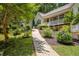 Landscaped front yard with a charming walkway leading to a cozy home with inviting curb appeal at 217 Bridgewater Trl, Canton, GA 30115