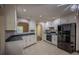 Well-lit kitchen with white cabinets, black appliances, and a functional layout for cooking convenience at 217 Bridgewater Trl, Canton, GA 30115