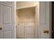 A laundry area contains a white washer and dryer located in a small closet at 217 Bridgewater Trl, Canton, GA 30115