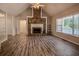 Open living room with vaulted ceilings, beautiful stone fireplace, and lots of natural light at 217 Bridgewater Trl, Canton, GA 30115