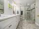 Elegant bathroom featuring double vanity with marble countertops, framed mirrors, and a glass-enclosed shower at 6300 Blackwater Trl, Atlanta, GA 30328