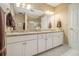 Bathroom featuring double sink vanity, granite countertop, and walk-in shower with glass doors at 6300 Blackwater Trl, Atlanta, GA 30328