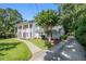 Two-story home with columns, set on a lot with green grass and mature trees at 6300 Blackwater Trl, Atlanta, GA 30328