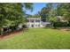 Traditional home with a lush green lawn and mature trees providing ample shade at 6300 Blackwater Trl, Atlanta, GA 30328