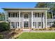 Stately two-story home with gray brick, black shutters, and prominent white columns at 6300 Blackwater Trl, Atlanta, GA 30328