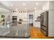 Well-lit kitchen featuring a large island with granite countertops and stainless steel refrigerator at 6300 Blackwater Trl, Atlanta, GA 30328