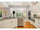 Bright kitchen with stainless steel dishwasher, sink, and view to the living room at 6300 Blackwater Trl, Atlanta, GA 30328