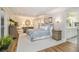 Inviting main bedroom boasting hardwood floors, a tray ceiling, plenty of natural light, and ensuite bathroom access at 6300 Blackwater Trl, Atlanta, GA 30328