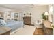 Relaxing main bedroom featuring hardwood floors, tray ceiling, natural light, and comfortable seating at 6300 Blackwater Trl, Atlanta, GA 30328