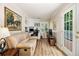 Bright office space with built-in shelving, a comfortable sofa, a desk area, and a door to the outside deck at 6300 Blackwater Trl, Atlanta, GA 30328