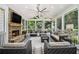 Inviting sunroom featuring a stone fireplace, vaulted ceilings, and comfortable seating at 6300 Blackwater Trl, Atlanta, GA 30328