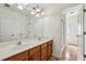 Bathroom featuring a double vanity, shower with glass door, and ample lighting at 2761 Valley Spring Dr, Lawrenceville, GA 30044