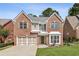 Charming two-story brick home featuring a well-manicured lawn and a two-car garage at 2761 Valley Spring Dr, Lawrenceville, GA 30044
