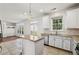 Bright kitchen features an island, tile floors, stainless steel appliances and plenty of cabinet space at 2761 Valley Spring Dr, Lawrenceville, GA 30044