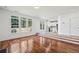 Sunlit living room features hardwood floors, large windows, and access to the kitchen at 2761 Valley Spring Dr, Lawrenceville, GA 30044