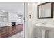 Elegant powder room with pedestal sink leading to a living room with a fireplace at 2761 Valley Spring Dr, Lawrenceville, GA 30044