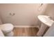 A powder room with vinyl flooring, pedestal sink, and toilet at 3165 Creston Park Ct, Duluth, GA 30096