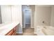 Bathroom featuring dual sinks, a soaking tub, and a walk-in closet at 3165 Creston Park Ct, Duluth, GA 30096