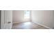 A small bedroom with vinyl flooring, a window, and light grey walls at 3165 Creston Park Ct, Duluth, GA 30096