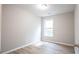 A bedroom with vinyl flooring, a window, and light grey walls at 3165 Creston Park Ct, Duluth, GA 30096