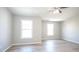 A bright bedroom with vinyl floors, and two windows at 3165 Creston Park Ct, Duluth, GA 30096
