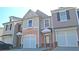 Well-maintained townhome showcasing integrated garages and inviting front entrances in a residential community at 3165 Creston Park Ct, Duluth, GA 30096