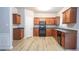Well-lit kitchen features ample wooden cabinetry, modern appliances, and wood-look flooring at 3165 Creston Park Ct, Duluth, GA 30096