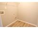 The laundry room is compact with hardwood floors and painted a neutral color at 3165 Creston Park Ct, Duluth, GA 30096