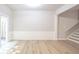 Bright living space with wood-look floors, wainscoting and staircase access to the upper level at 3165 Creston Park Ct, Duluth, GA 30096