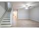 Open-concept living area with wood-look floors, staircase, and a light and airy ambiance at 3165 Creston Park Ct, Duluth, GA 30096