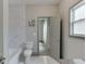 Bathroom with tiled floors, a bathtub, tiled walls, toilet, and vanity sink at 4208 Sierra Creek Ct, Hoschton, GA 30548