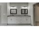 Bathroom featuring double sinks, framed mirrors, and modern lighting fixtures at 4208 Sierra Creek Ct, Hoschton, GA 30548
