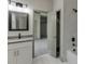 Modern bathroom with sleek vanity, framed mirror, and marble-look tile surround in a new construction home at 4208 Sierra Creek Ct, Hoschton, GA 30548