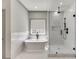 Bathroom featuring a soaking tub and shower with glass surround at 4208 Sierra Creek Ct, Hoschton, GA 30548