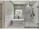 Bright bathroom featuring a standalone tub, sleek black fixtures, and a glass enclosed shower at 4208 Sierra Creek Ct, Hoschton, GA 30548