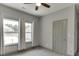 Bedroom with neutral paint, carpeted floors, ceiling fan, and two windows with curtains at 4208 Sierra Creek Ct, Hoschton, GA 30548