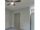 Bedroom features neutral paint, carpeted floors, and a ceiling fan with two doors at 4208 Sierra Creek Ct, Hoschton, GA 30548