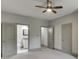 This primary bedroom features neutral paint, ceiling fan, carpet, ensuite bathroom, and walk-in closet at 4208 Sierra Creek Ct, Hoschton, GA 30548