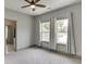 Bedroom with neutral paint, carpeted floors, ceiling fan, and two windows with curtains at 4208 Sierra Creek Ct, Hoschton, GA 30548