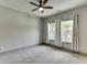 This bedroom offers plenty of natural light from its two windows and features a ceiling fan at 4208 Sierra Creek Ct, Hoschton, GA 30548