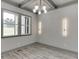 Formal dining area with modern lighting, hardwood floors, and ample natural light at 4208 Sierra Creek Ct, Hoschton, GA 30548