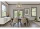 Bright dining room with large windows, a modern light fixture, and a stylish sideboard at 4208 Sierra Creek Ct, Hoschton, GA 30548