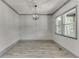 Formal dining room with hardwood floors, modern lighting, and large windows at 4208 Sierra Creek Ct, Hoschton, GA 30548