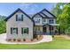 Beautiful two-story home with a stone facade, black accents, and a well-manicured front yard at 4208 Sierra Creek Ct, Hoschton, GA 30548